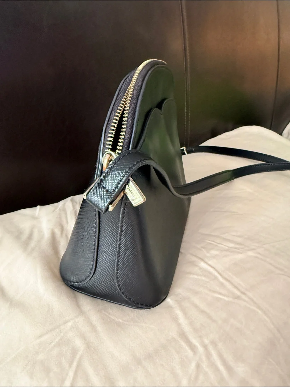 Kate Spade New York Payton Dome Crossbody in black saffiano leather.